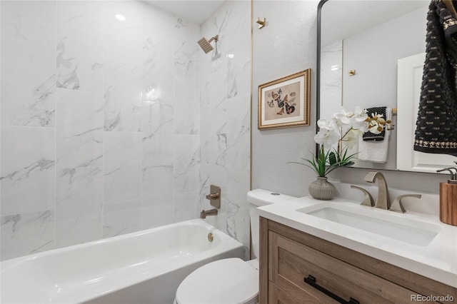 full bathroom featuring tiled shower / bath combo, toilet, and vanity