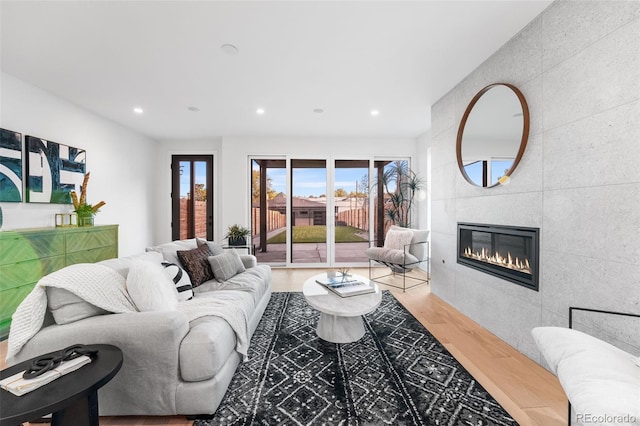 living room with hardwood / wood-style floors and a fireplace