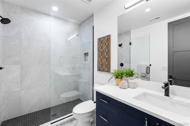 bathroom featuring vanity, toilet, and a shower with shower door