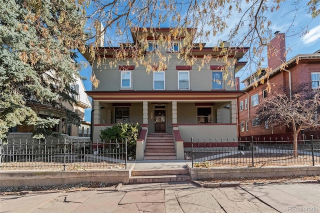 1450 N High St Unit 3, Denver, CO 80218 - view of front facade with a porch and a fenced front yard