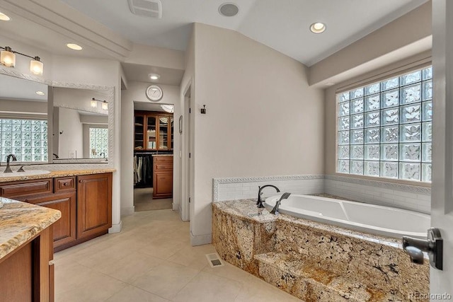 bathroom with vanity, a garden tub, tile patterned floors, and recessed lighting
