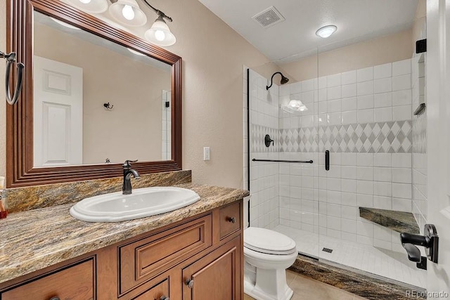 full bath featuring tiled shower, toilet, and vanity
