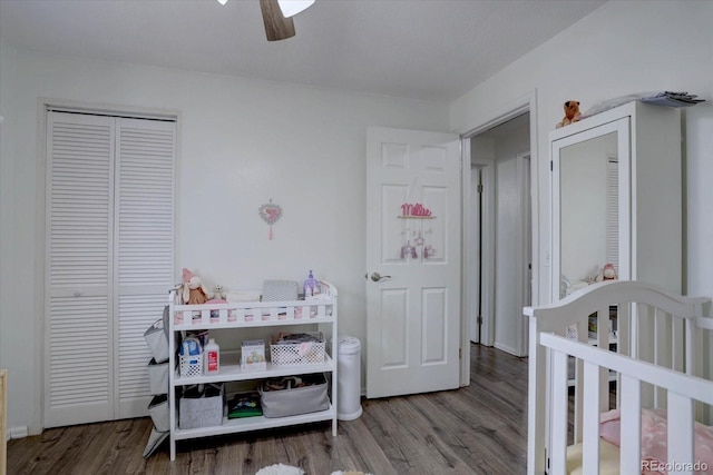 bedroom with a closet, wood finished floors, and a ceiling fan