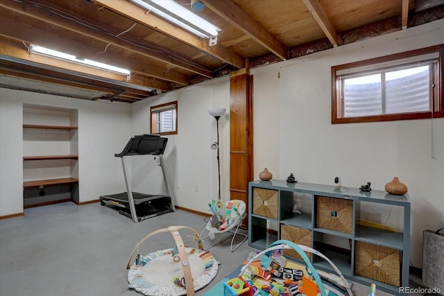 playroom featuring concrete flooring and baseboards