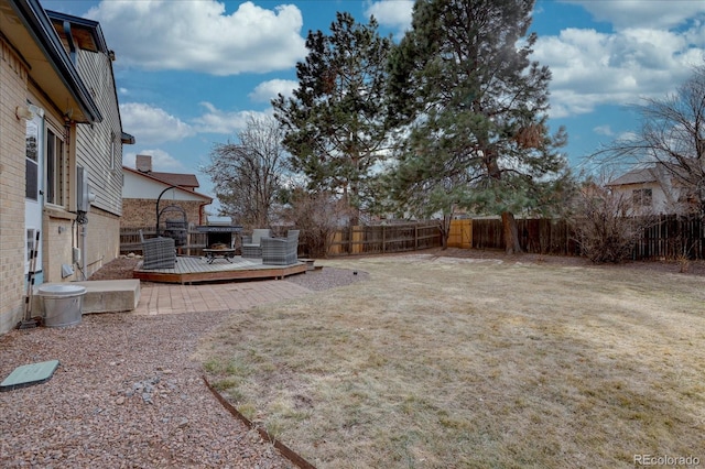 view of yard featuring a fenced backyard and a wooden deck