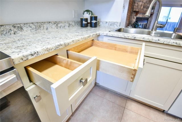 kitchen with light tile patterned floors and a sink