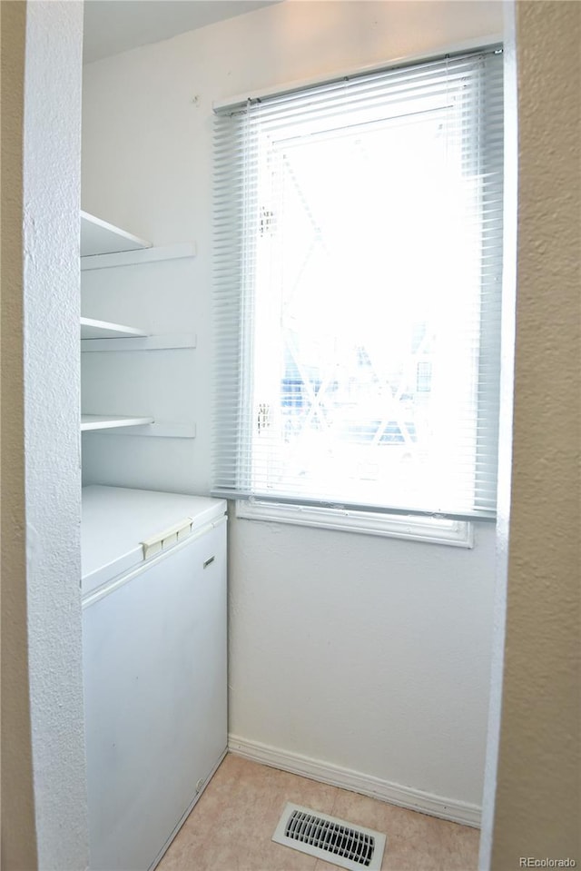 laundry room featuring baseboards and visible vents