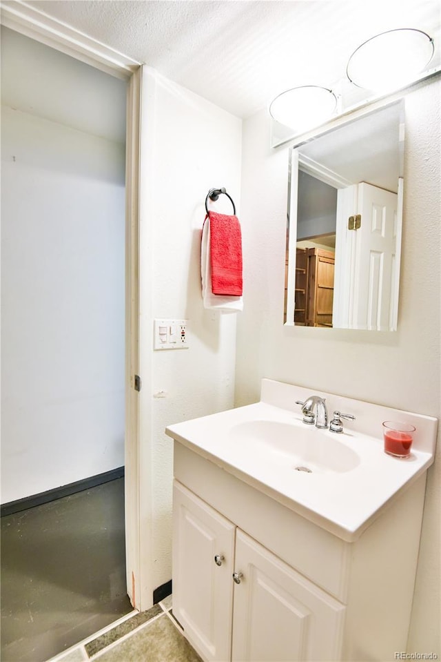 bathroom featuring tile patterned flooring, a textured ceiling, and vanity