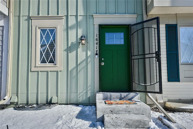 1641 S Idalia Cir Unit F, Aurora, CO 80017 - snow covered property entrance featuring board and batten siding