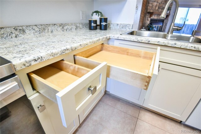 1641 S Idalia Cir Unit F, Aurora, CO 80017 - kitchen featuring a sink, light countertops, and light tile patterned floors