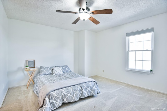 1641 S Idalia Cir Unit F, Aurora, CO 80017 - bedroom featuring a textured ceiling, light carpet, baseboards, and a ceiling fan