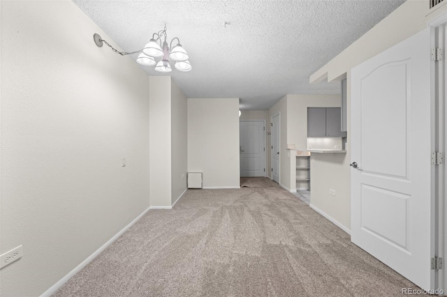 interior space featuring an inviting chandelier and a textured ceiling