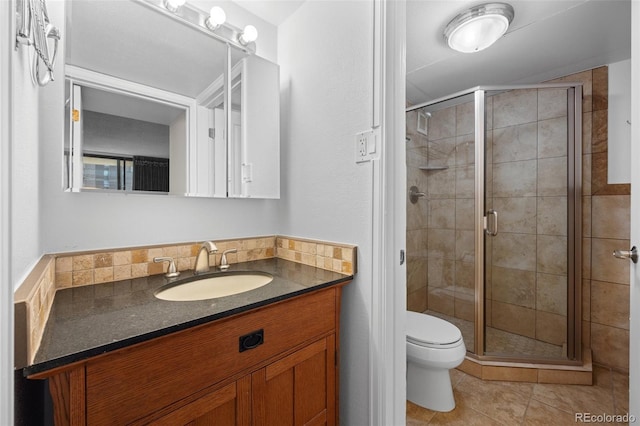 bathroom featuring vanity, tile patterned flooring, toilet, and walk in shower