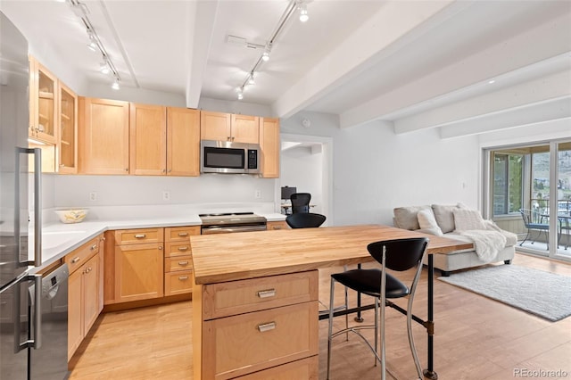 220 E Ln Bonte St Unit 317, Dillon, CO 80435 - kitchen featuring stainless steel appliances, light brown cabinetry, rail lighting, open floor plan, and beam ceiling