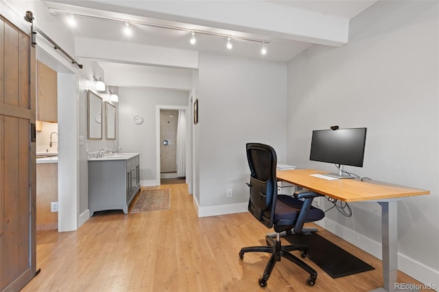 220 E Ln Bonte St Unit 317, Dillon, CO 80435 - office space with light wood-type flooring, baseboards, a sink, rail lighting, and a barn door