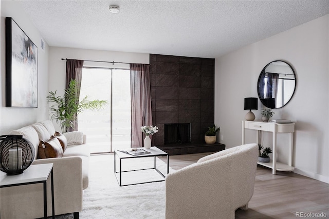 7395 E Eastman Ave Unit 202N, Denver, CO 80231 - living room with wood finished floors, a textured ceiling, and baseboards