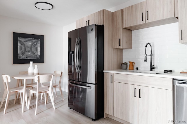 7395 E Eastman Ave Unit 202N, Denver, CO 80231 - kitchen with refrigerator with ice dispenser, light brown cabinets, stainless steel dishwasher, and light countertops