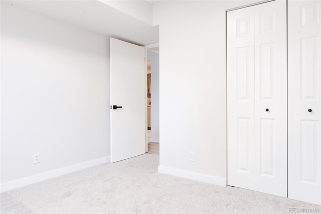 7395 E Eastman Ave Unit 202N, Denver, CO 80231 - unfurnished bedroom featuring carpet, a closet, and baseboards