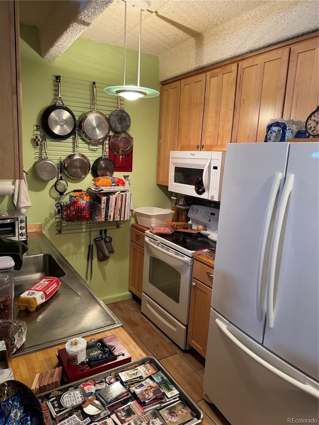 1888 S Jackson St Unit 404, Denver, CO 80210 - kitchen with white appliances, light wood-style flooring, and brown cabinetry