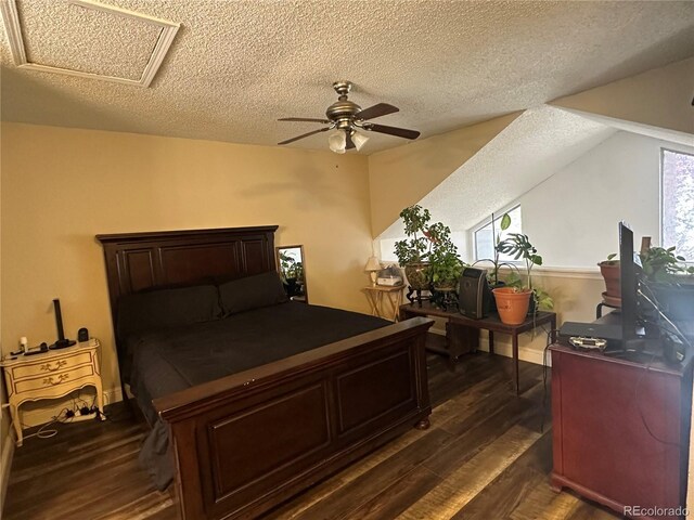 11576 E Bayaud Dr, Aurora, CO 80012 - bedroom with a textured ceiling, dark wood-style flooring, a ceiling fan, and attic access
