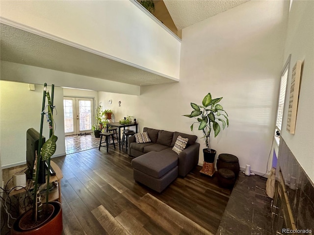 11576 E Bayaud Dr, Aurora, CO 80012 - living room with french doors, high vaulted ceiling, a textured ceiling, and wood finished floors
