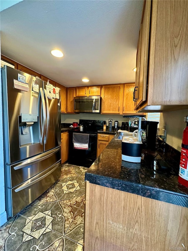 11576 E Bayaud Dr, Aurora, CO 80012 - kitchen with appliances with stainless steel finishes, tile counters, brown cabinetry, and recessed lighting