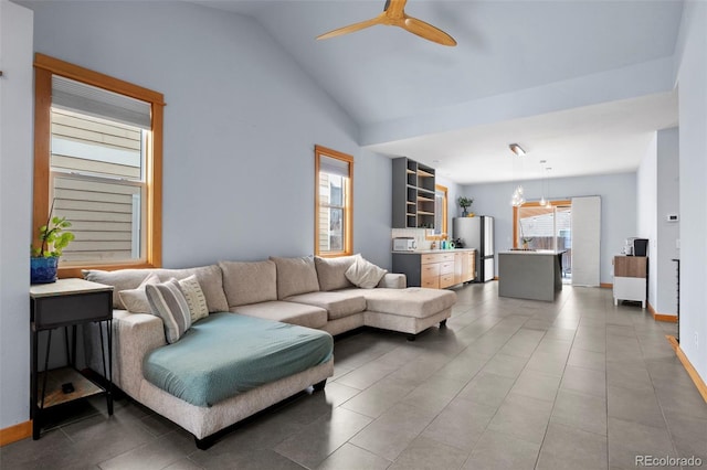 living room featuring ceiling fan and lofted ceiling