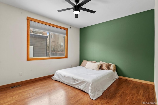 bedroom featuring hardwood / wood-style flooring and ceiling fan