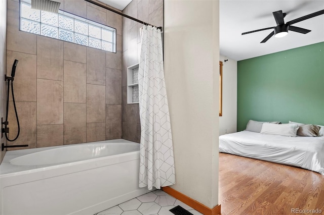 bathroom featuring ceiling fan and shower / bath combination with curtain