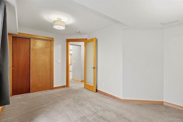 unfurnished bedroom with carpet flooring and a closet