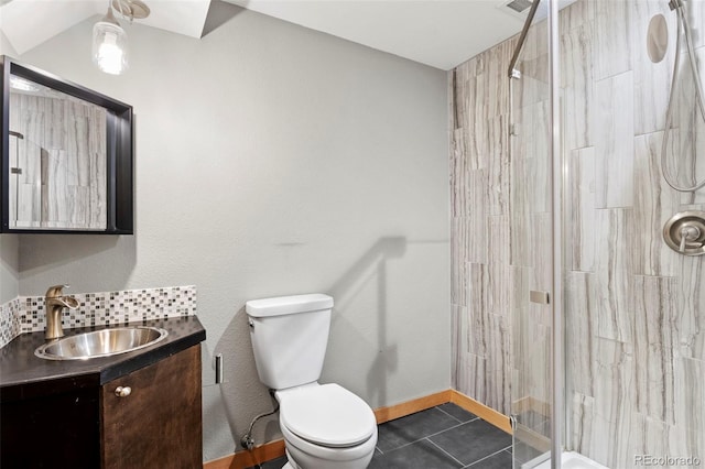 bathroom with vanity, a shower with door, tile patterned floors, toilet, and tasteful backsplash