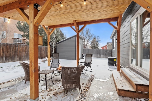 snow covered patio featuring central AC