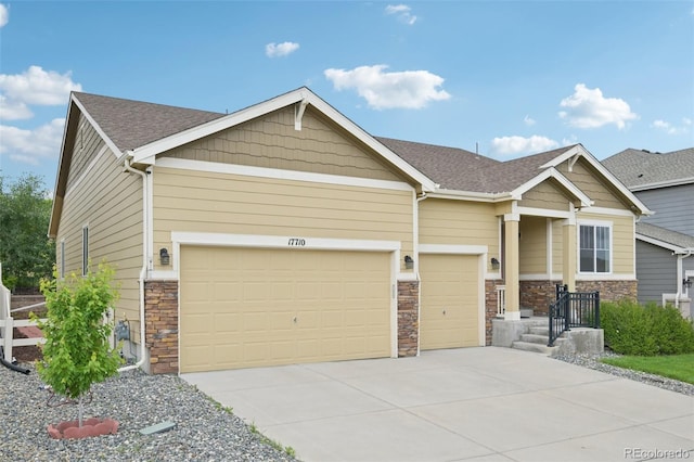 17710 E Emilia Dr, Parker, CO 80134 - craftsman-style house featuring stone siding, a garage, driveway, and roof with shingles