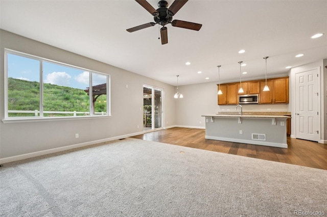 17710 E Emilia Dr, Parker, CO 80134 - unfurnished living room with recessed lighting, carpet flooring, a ceiling fan, and wood finished floors
