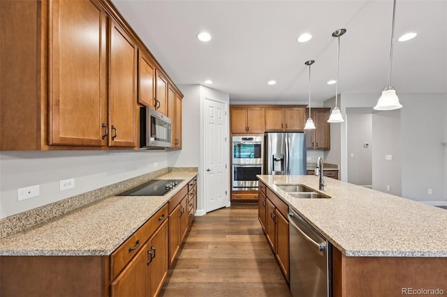 17710 E Emilia Dr, Parker, CO 80134 - kitchen featuring stainless steel appliances, dark wood-style flooring, brown cabinetry, recessed lighting, and an island with sink
