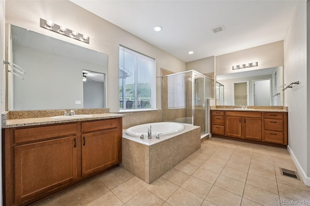 17710 E Emilia Dr, Parker, CO 80134 - bathroom featuring a stall shower, tile patterned flooring, two vanities, a garden tub, and a ceiling fan