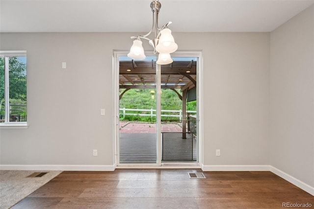 17710 E Emilia Dr, Parker, CO 80134 - unfurnished dining area featuring a chandelier and wood finished floors