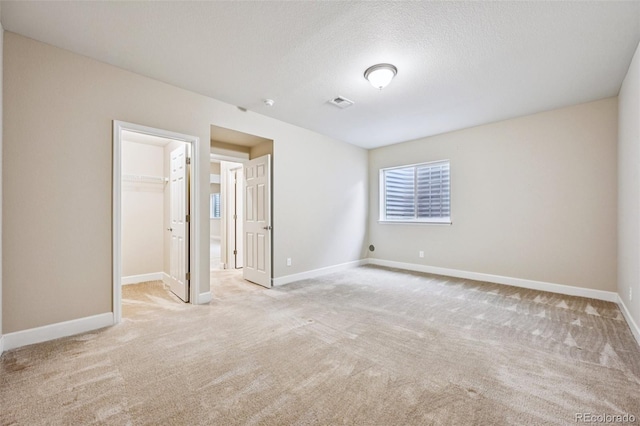17710 E Emilia Dr, Parker, CO 80134 - unfurnished bedroom featuring carpet floors, a spacious closet, a closet, and a textured ceiling