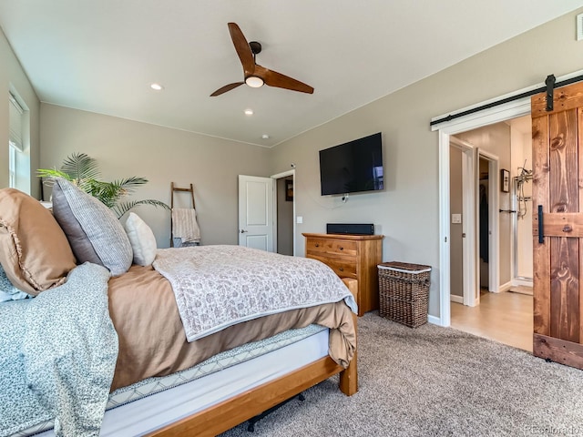 7702 E 157th Ave, Thornton, CO 80602 - carpeted bedroom featuring a barn door, recessed lighting, and a ceiling fan