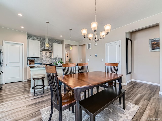 7702 E 157th Ave, Thornton, CO 80602 - dining space featuring light wood-type flooring, a chandelier, and recessed lighting