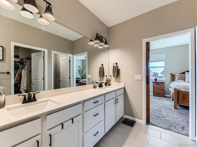 7702 E 157th Ave, Thornton, CO 80602 - full bath with ensuite bathroom, double vanity, tile patterned floors, and a spacious closet