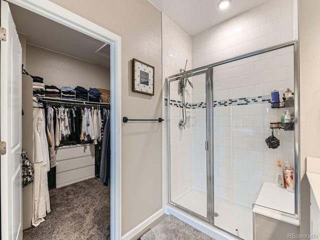 7702 E 157th Ave, Thornton, CO 80602 - bathroom featuring a stall shower and a walk in closet
