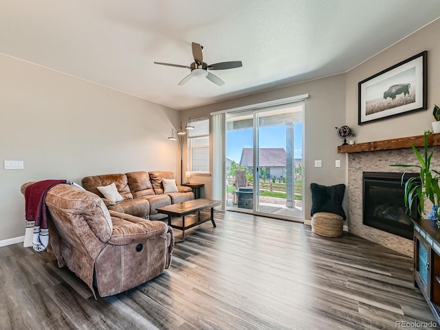 7702 E 157th Ave, Thornton, CO 80602 - living area with wood finished floors, ceiling fan, and a glass covered fireplace