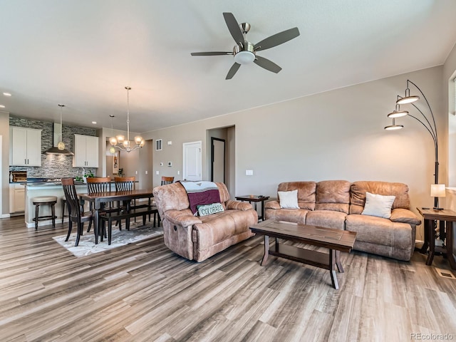 7702 E 157th Ave, Thornton, CO 80602 - living room featuring light wood-type flooring, a chandelier, a ceiling fan, and recessed lighting