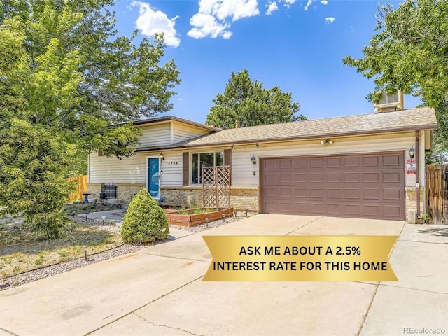 15705 E Brown Ave, Aurora, CO 80013 - tri-level home with a garage, brick siding, and concrete driveway