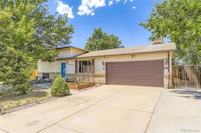 15705 E Brown Ave, Aurora, CO 80013 - tri-level home featuring brick siding, an attached garage, and driveway