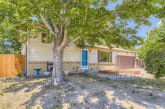 15705 E Brown Ave, Aurora, CO 80013 - view of front of house with brick siding and an attached garage
