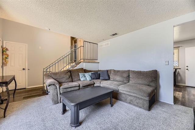 15705 E Brown Ave, Aurora, CO 80013 - living area featuring stairs, wood finished floors, and a textured ceiling
