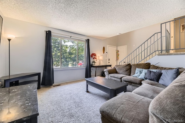 15705 E Brown Ave, Aurora, CO 80013 - living area with carpet flooring, stairway, and a textured ceiling