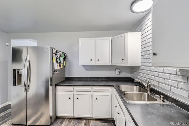 15705 E Brown Ave, Aurora, CO 80013 - kitchen with stainless steel fridge, white cabinetry, dark countertops, and wood finished floors